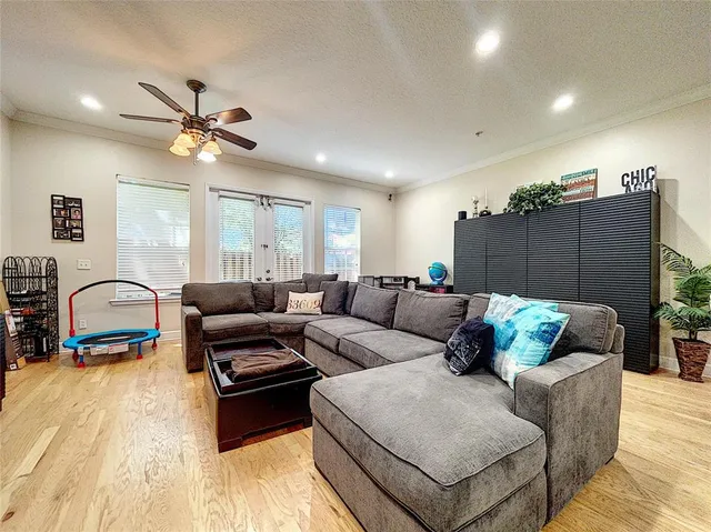 a living room with furniture ceiling fan and a rug