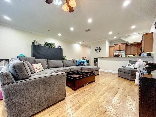 a living room with furniture and kitchen view
