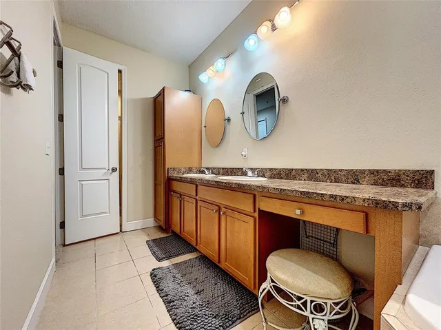 a bathroom with a granite countertop sink a mirror and a toilet