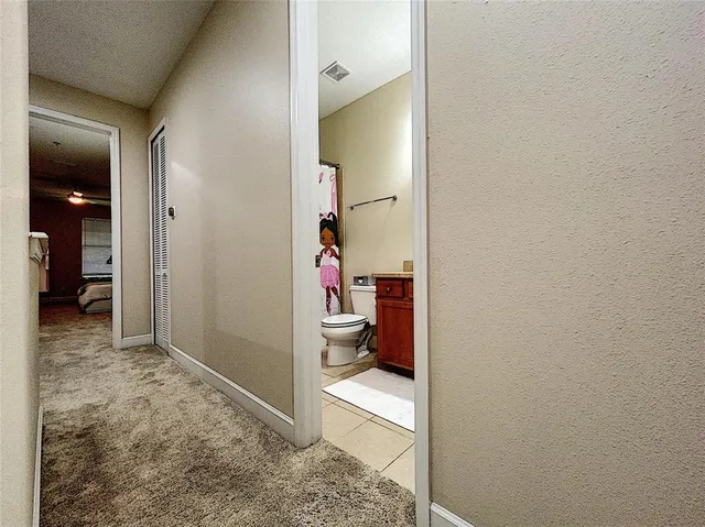 a bathroom with a granite countertop toilet sink and mirror