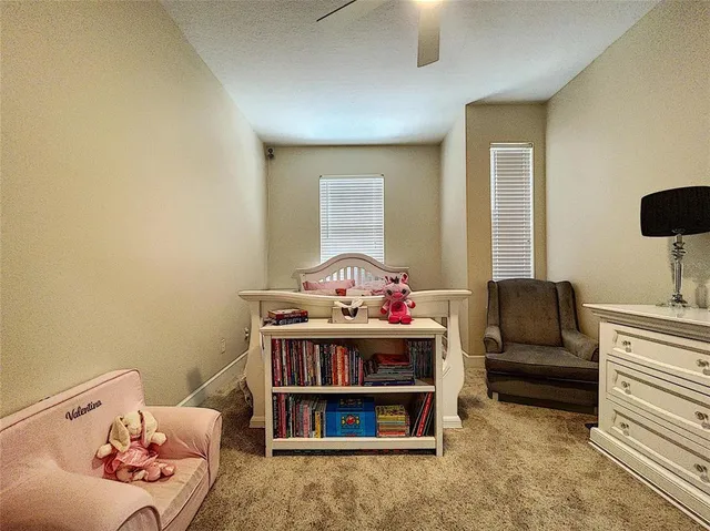 an aerial view of a house with swimming pool and a yard