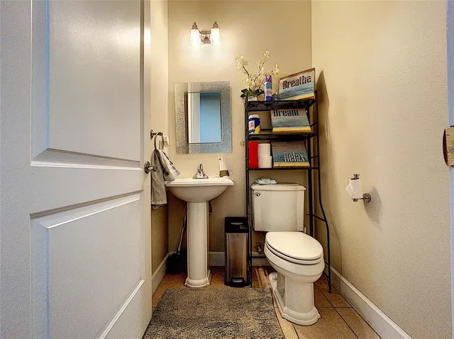 a bathroom with a sink toilet and mirror