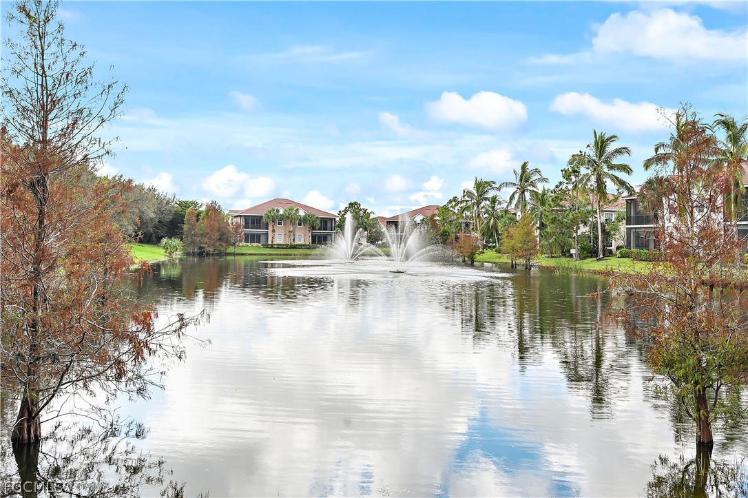 a view of a lake with houses in the back