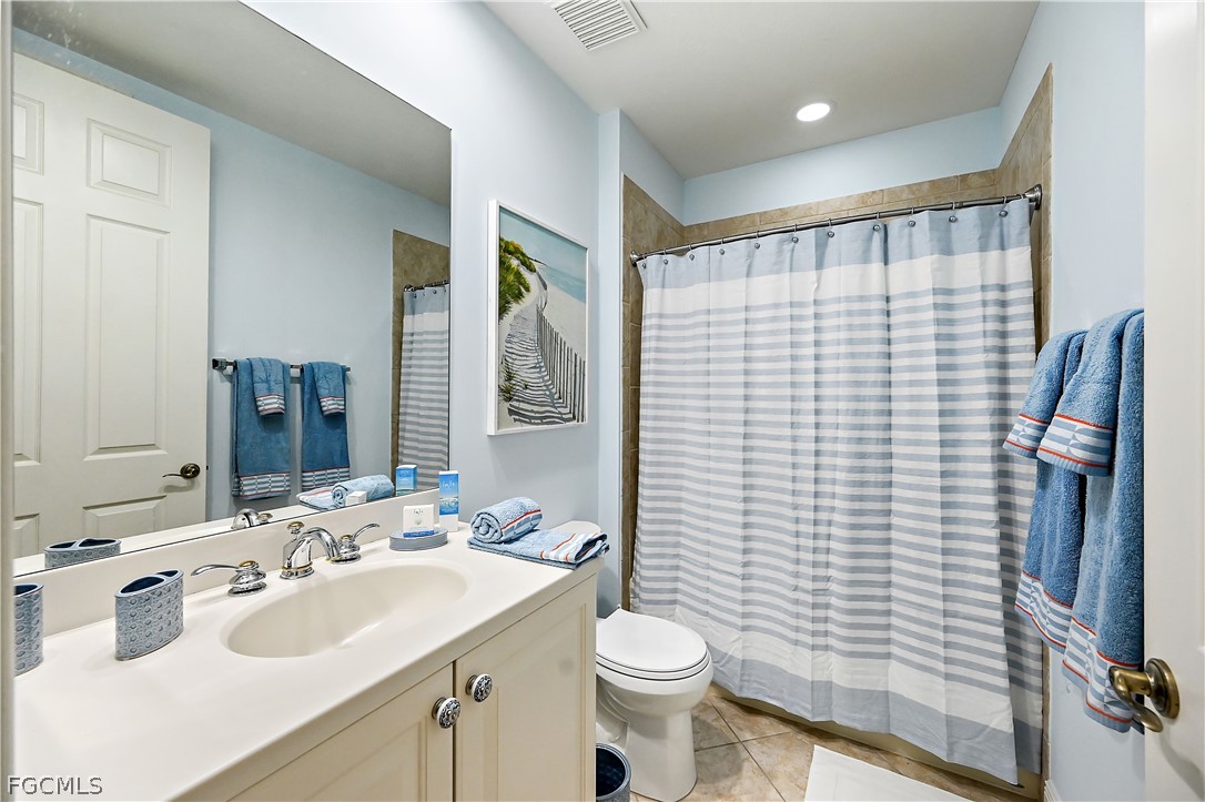 7832 Hawthorne Drive, Unit 1901 Naples, FL 34113 - Photo 18 of 26 a bathroom with a sink toilet and shower