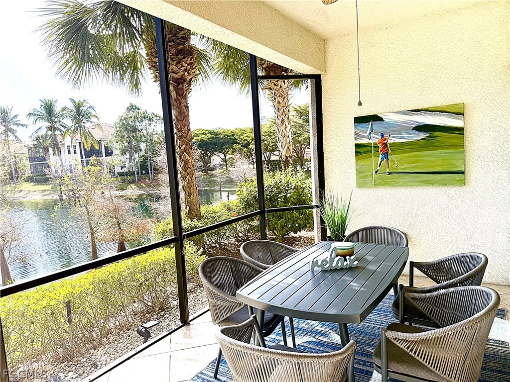 7832 Hawthorne Drive, Unit 1901 Naples, FL 34113 - Photo 22 of 26 a dining room with furniture and a floor to ceiling window