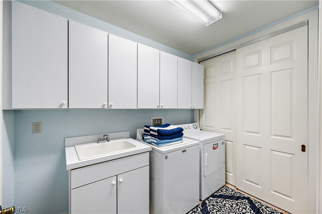 7832 Hawthorne Drive, Unit 1901 Naples, FL 34113 - Photo 23 of 26 a utility room with sink dryer and washer