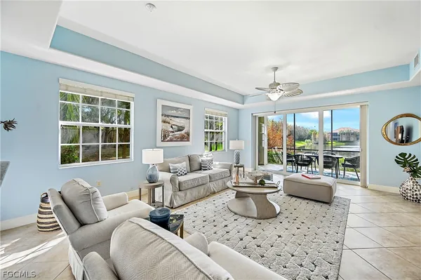 a living room with furniture and large windows