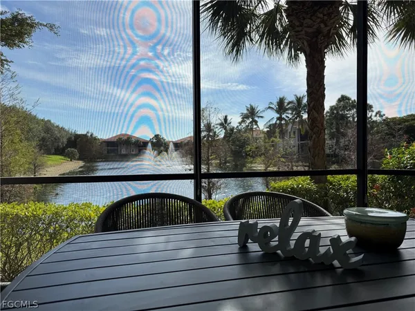 a view of a swimming pool with a table and chairs