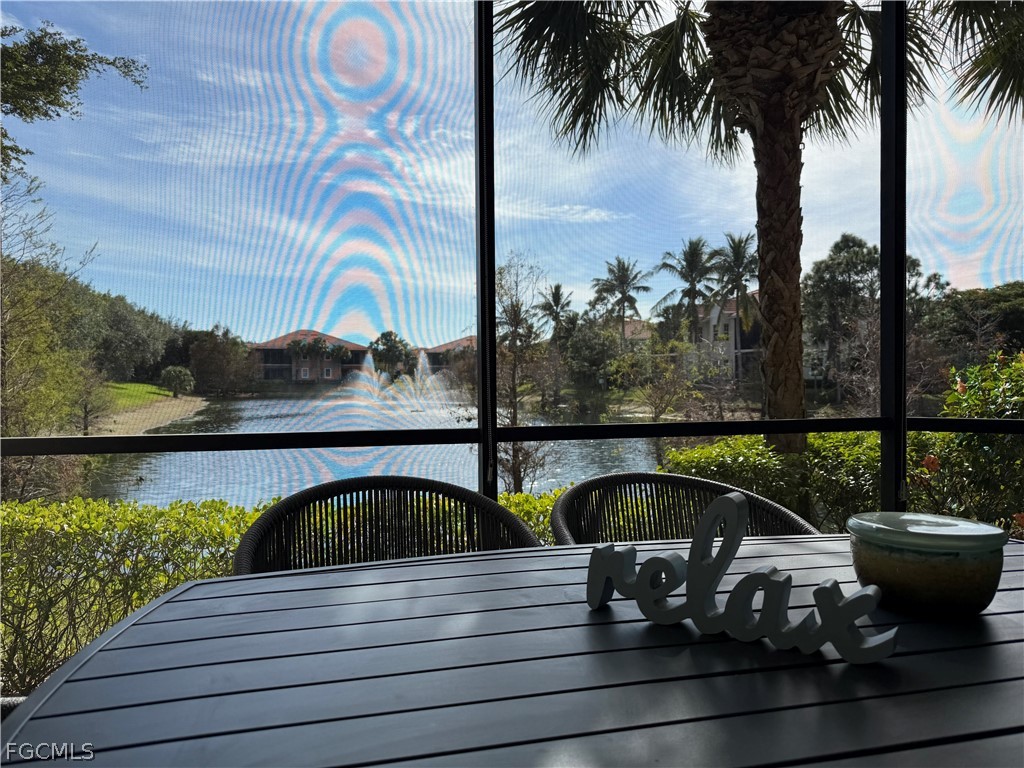 7832 Hawthorne Drive, Unit 1901 Naples, FL 34113 - Photo 8 of 26 a view of a swimming pool with a table and chairs