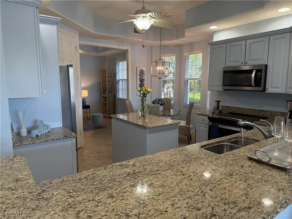 a kitchen with kitchen island a sink stainless steel appliances and cabinets