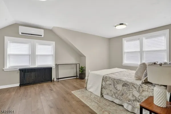 a spacious bedroom with a bed and a window