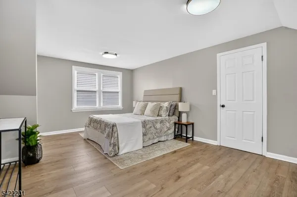 a bedroom with a bed and a lamp