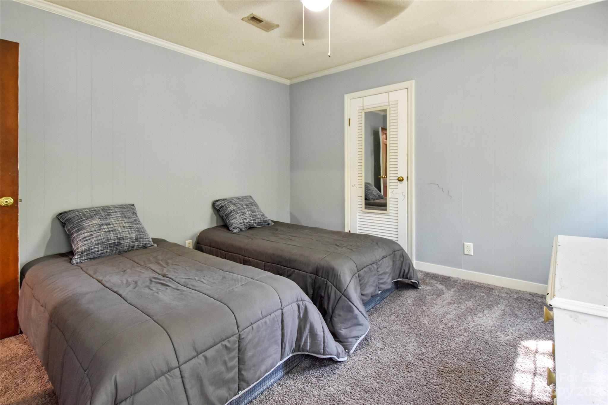 3199 Greenwood Road Rock Hill, SC 29730 - Photo 25 of 33 a bedroom with a bed and a chandelier fan