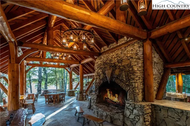 a view of a patio with table and chairs potted plants and large tree