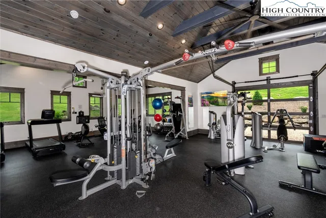 a sign board with grassy field and trees