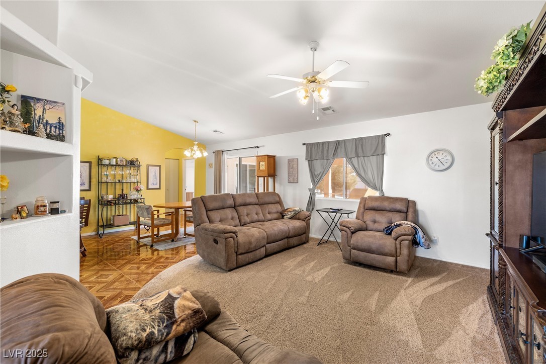 81 Diamond Bar Road Pahrump, NV 89048 - Photo 6 of 38 Living room with visible vents, vaulted ceiling, and a ceiling fan