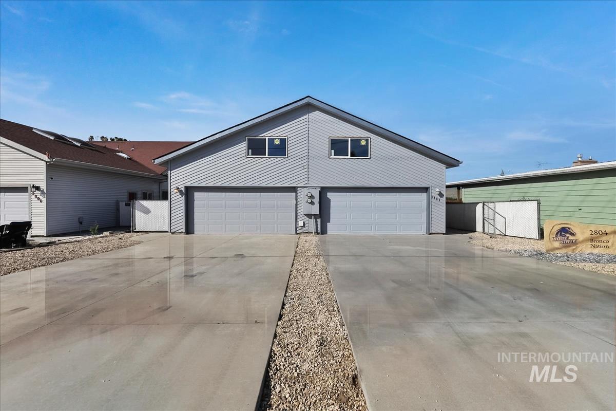 2804 West Sunrise Rim Road Boise, ID 83705 - Photo 2 of 50 Duplex exterior with gray siding and dual two-car garages