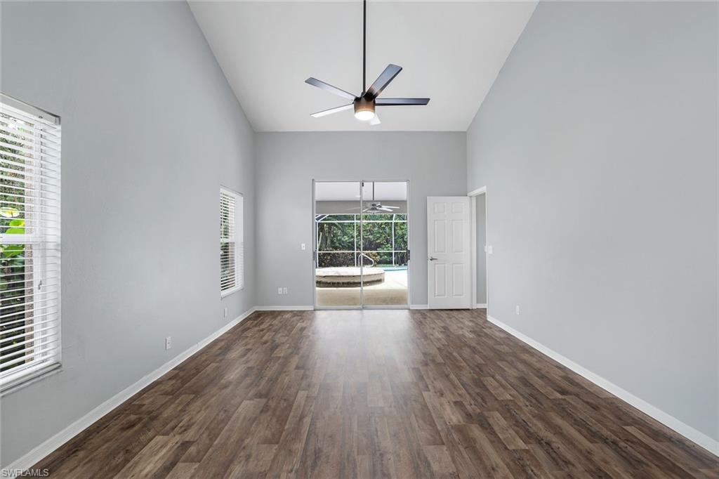 7786 Scarlet Court Naples, FL 34104 - Photo 12 of 19 a view of an empty room with wooden floor and a window