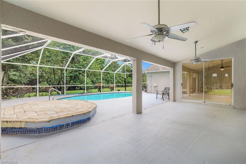 7786 Scarlet Court Naples, FL 34104 - Photo 18 of 19 a view of a room with a large window and chandelier