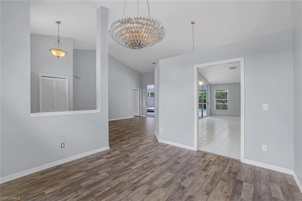 7786 Scarlet Court Naples, FL 34104 - Photo 5 of 19 a view of a hallway with wooden floor and a kitchen