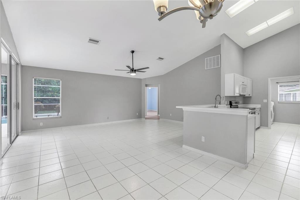 7786 Scarlet Court Naples, FL 34104 - Photo 9 of 19 a view of a kitchen with marble kitchen and sink
