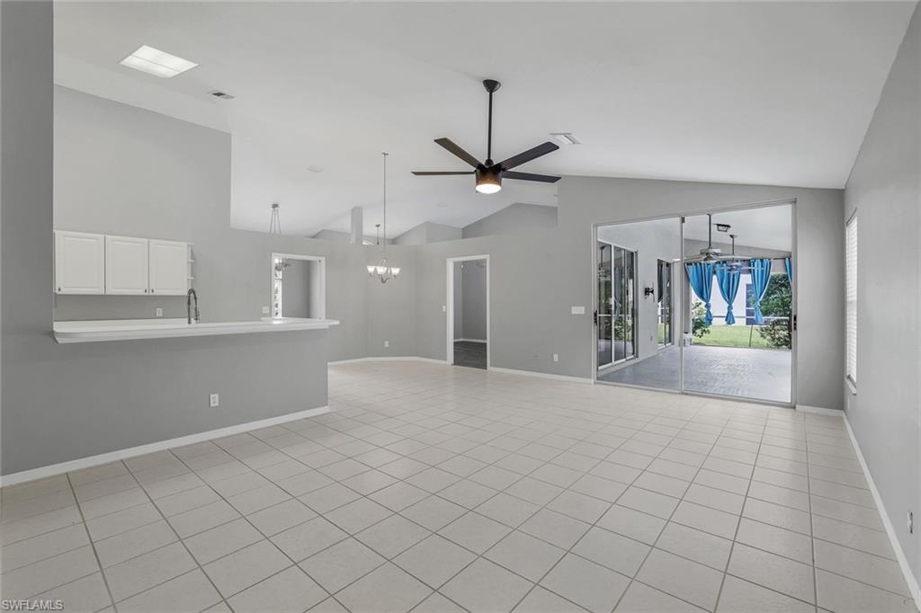 7786 Scarlet Court Naples, FL 34104 - Photo 10 of 19 a view of a kitchen with furniture and a chandelier fan