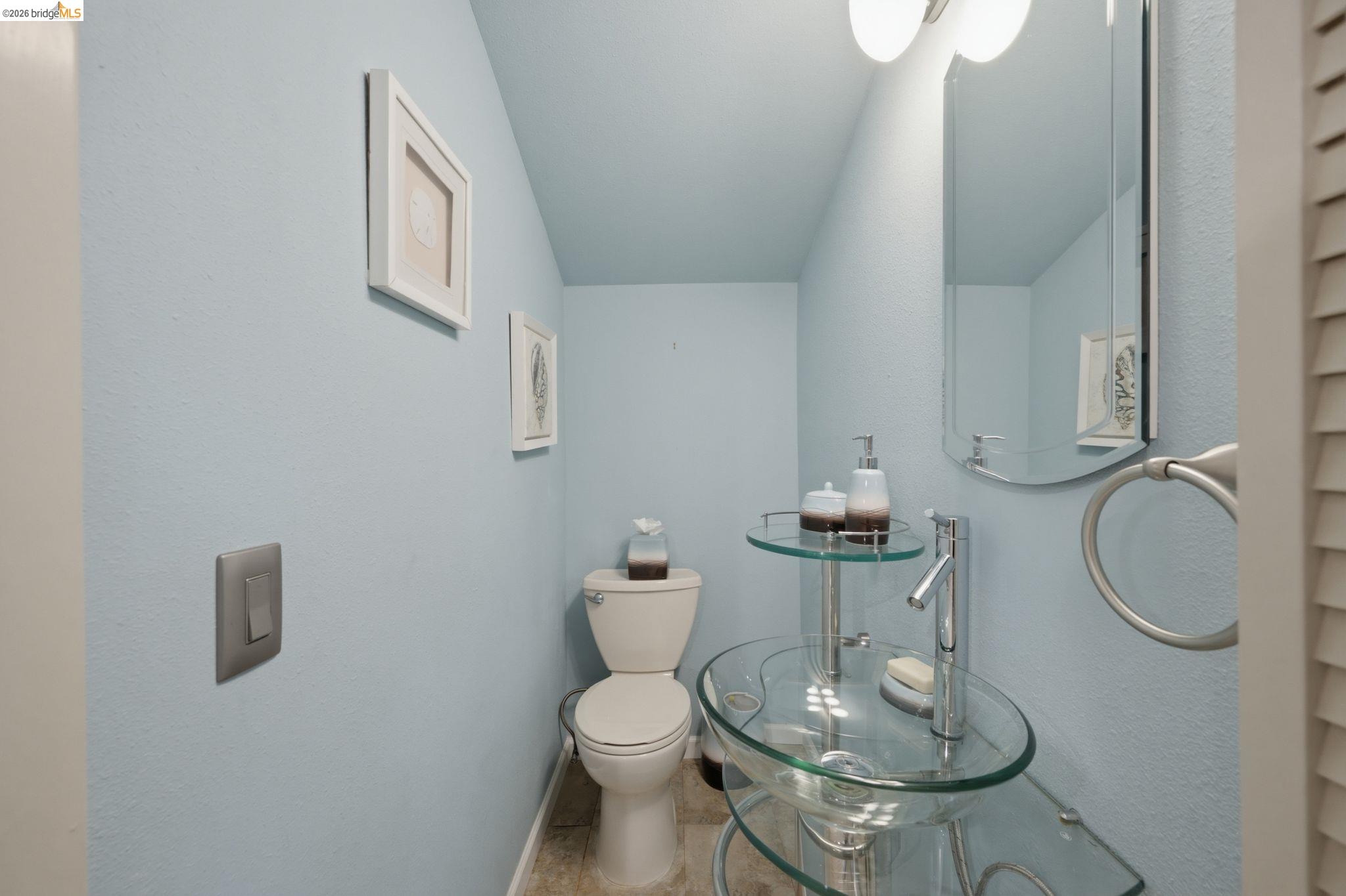 11133 Golf Links Road Oakland, CA 94605 - Photo 44 of 57 Pedestal glass sink with chrome fixtures and wall-mounted mirror