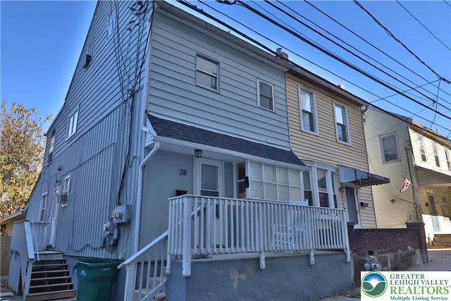 a view of a house with a small yard