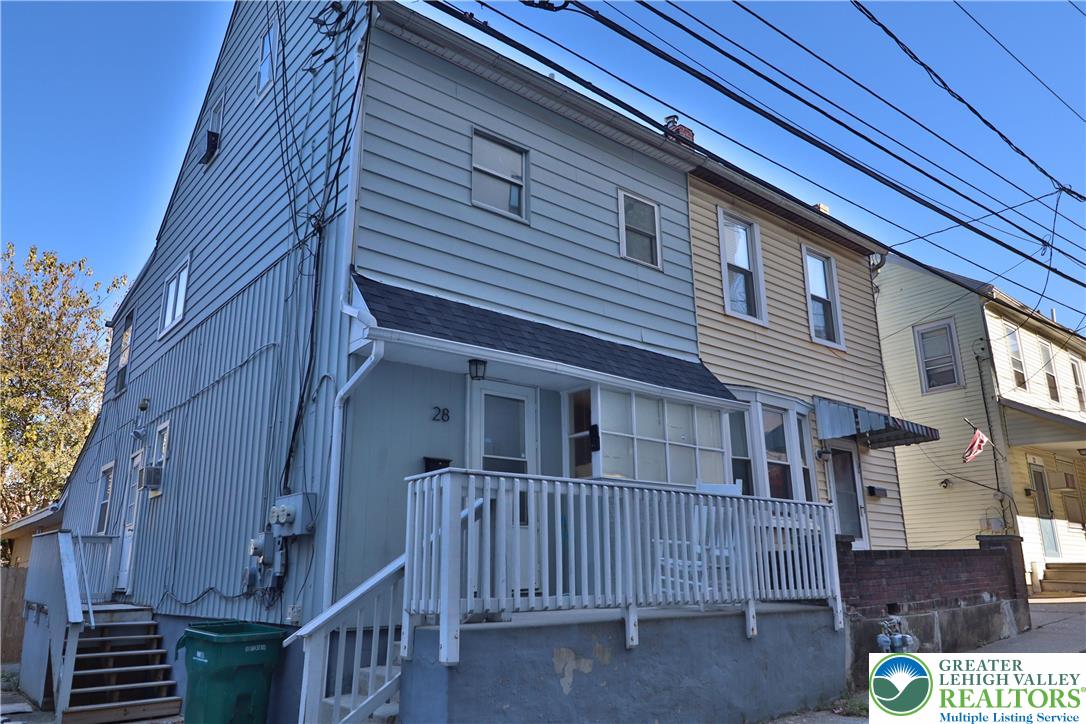 a view of a house with a small yard