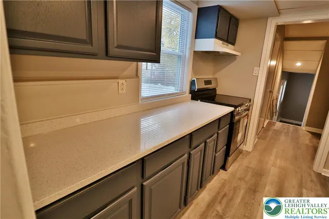 a kitchen with stainless steel appliances a refrigerator and cabinets