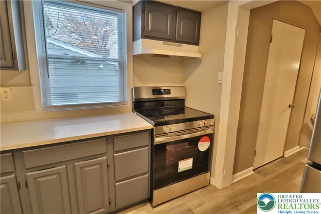 a kitchen with a stove and a microwave