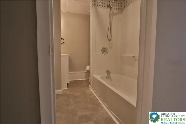 a bathroom with a tub and shower
