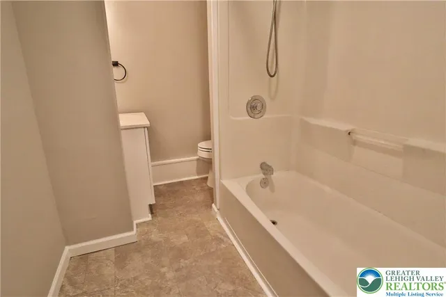 a bathroom with a tub a sink and a shower