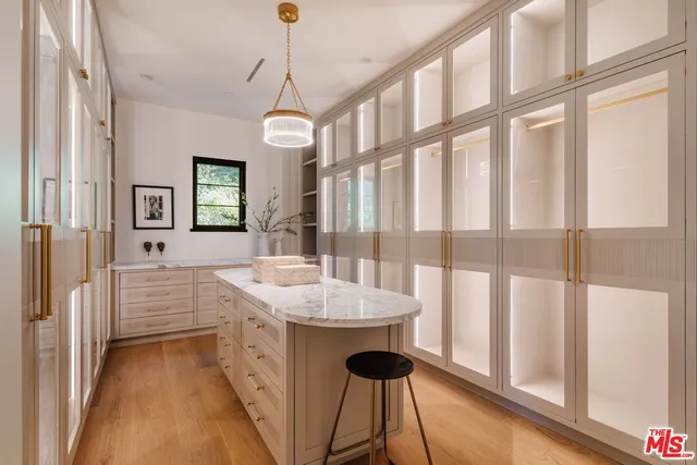a spacious bathroom with a granite countertop sink a mirror and a bathtub