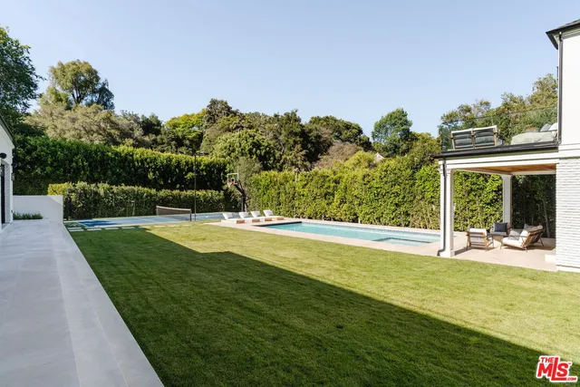a view of a swimming pool with a yard