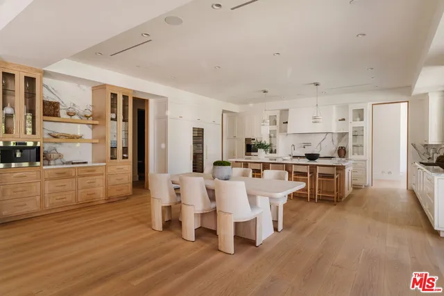 a large kitchen with a table and chairs