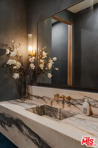 a bathroom with a sink and a mirror