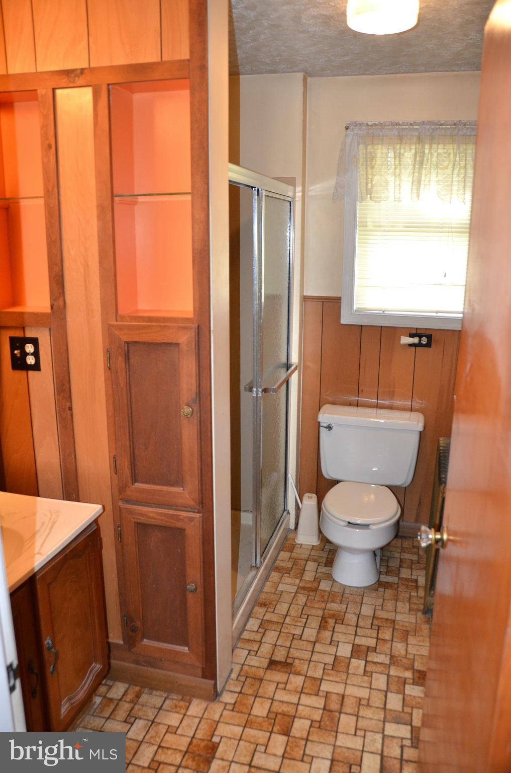 1637 Hilltop Road Edgewater, MD 21037 - Photo 2 of 20 a bathroom with a toilet a sink and a shower