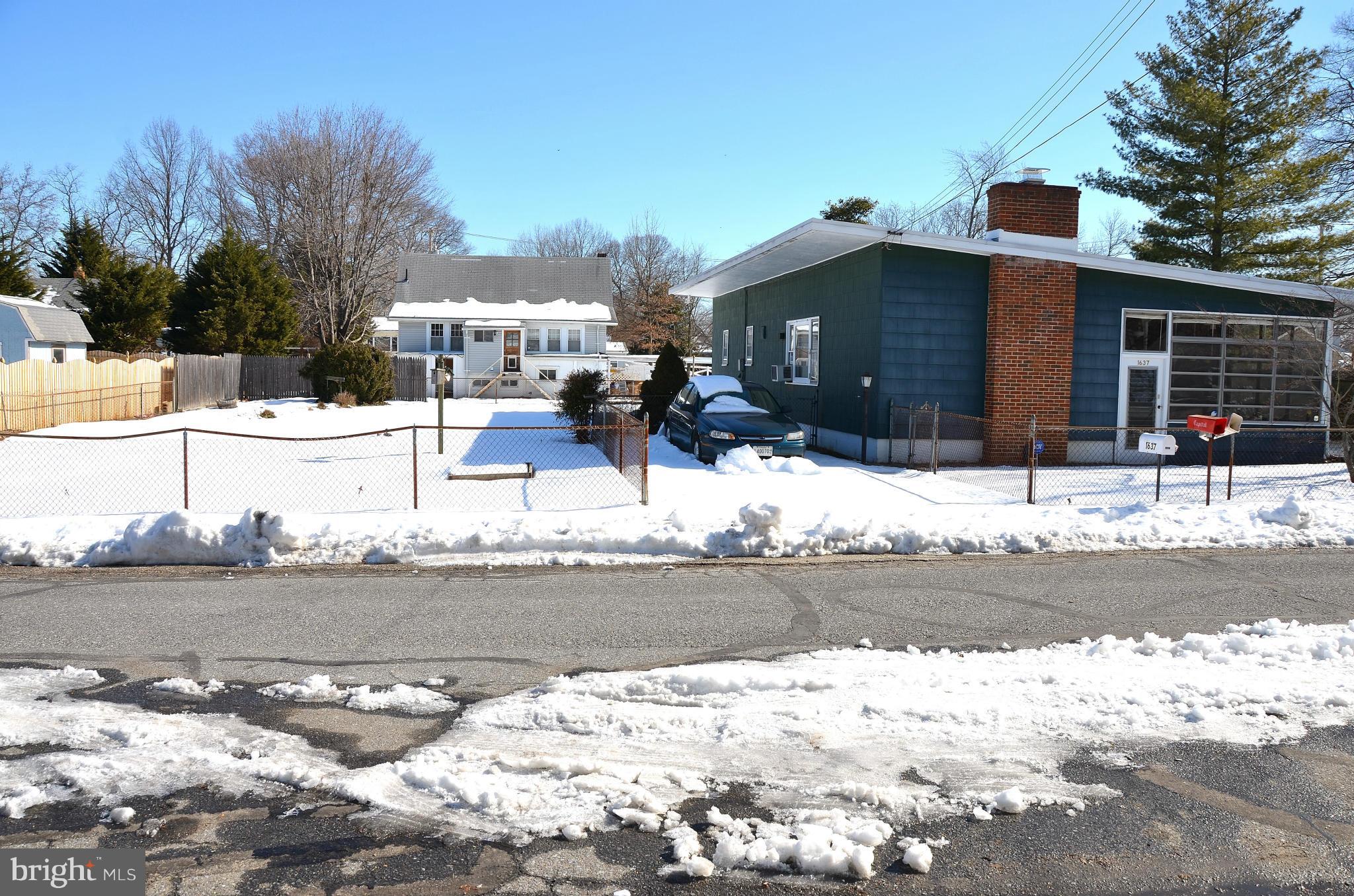 1637 Hilltop Road Edgewater, MD 21037 - Photo 4 of 20 a view of a house with snow on the side of the road