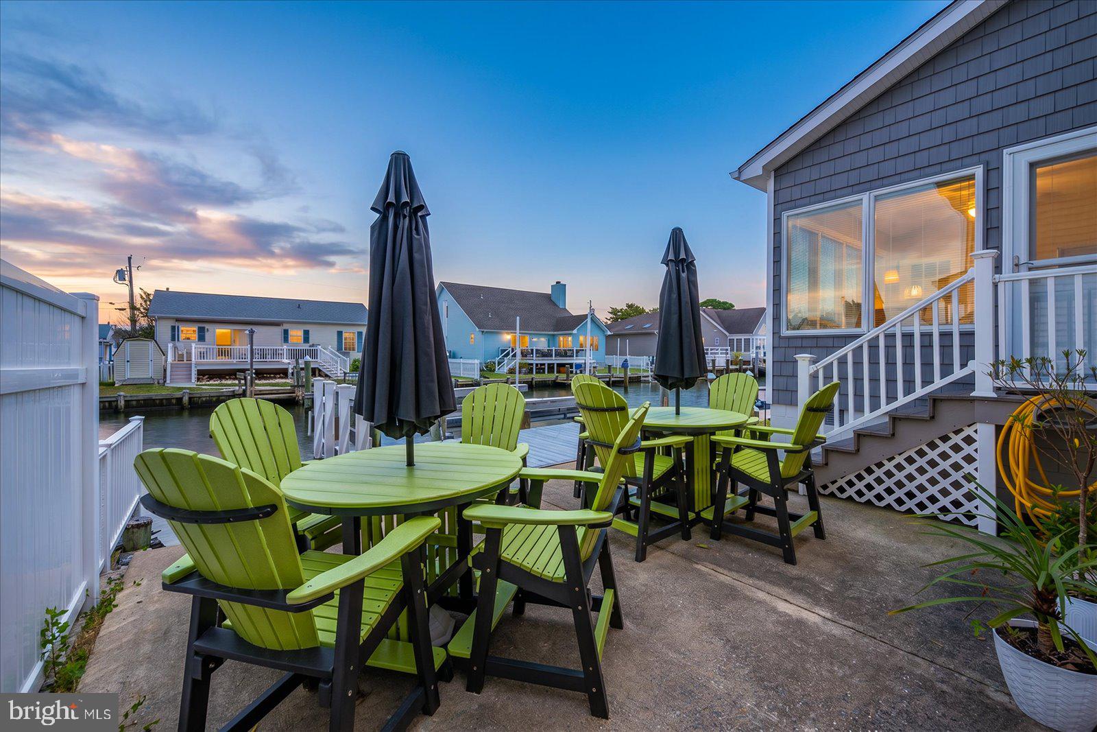 10362 Keyser Point Road Ocean City, MD 21842 - Photo 5 of 51 Charming waterfront patio at dusk.