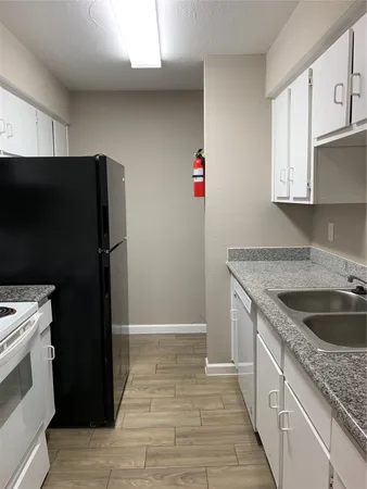 a kitchen with a sink stove and refrigerator