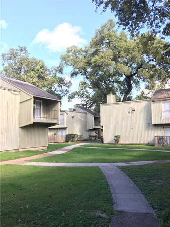 a view of a house with a backyard and a tree