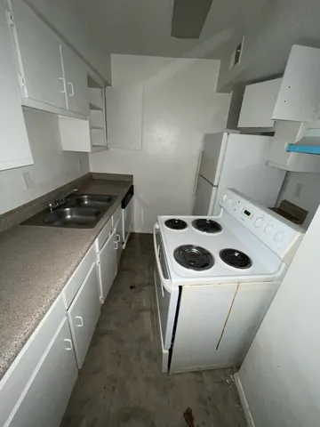 a kitchen with a stove and a refrigerator