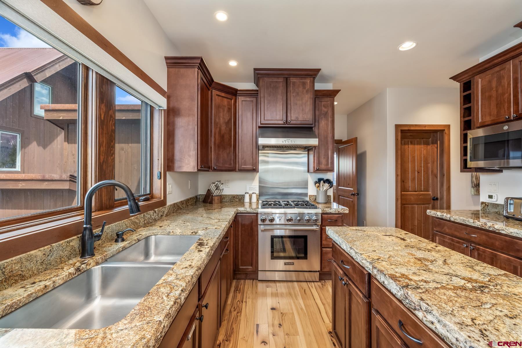 32 Cinnamon Mountain Road Crested Butte, CO 81225 - Photo 15 of 44 a kitchen with stainless steel appliances granite countertop a sink stove and refrigerator