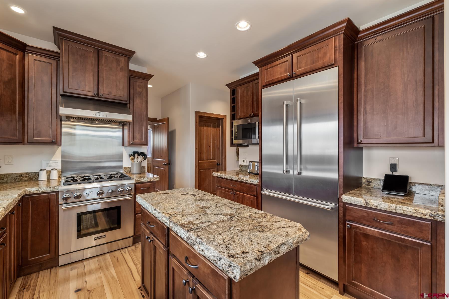32 Cinnamon Mountain Road Crested Butte, CO 81225 - Photo 16 of 44 a kitchen with granite countertop a sink stove and refrigerator