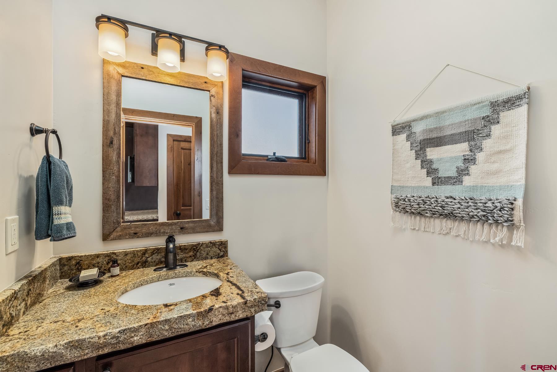 32 Cinnamon Mountain Road Crested Butte, CO 81225 - Photo 20 of 44 a bathroom with a granite countertop sink vanity mirror and toilet