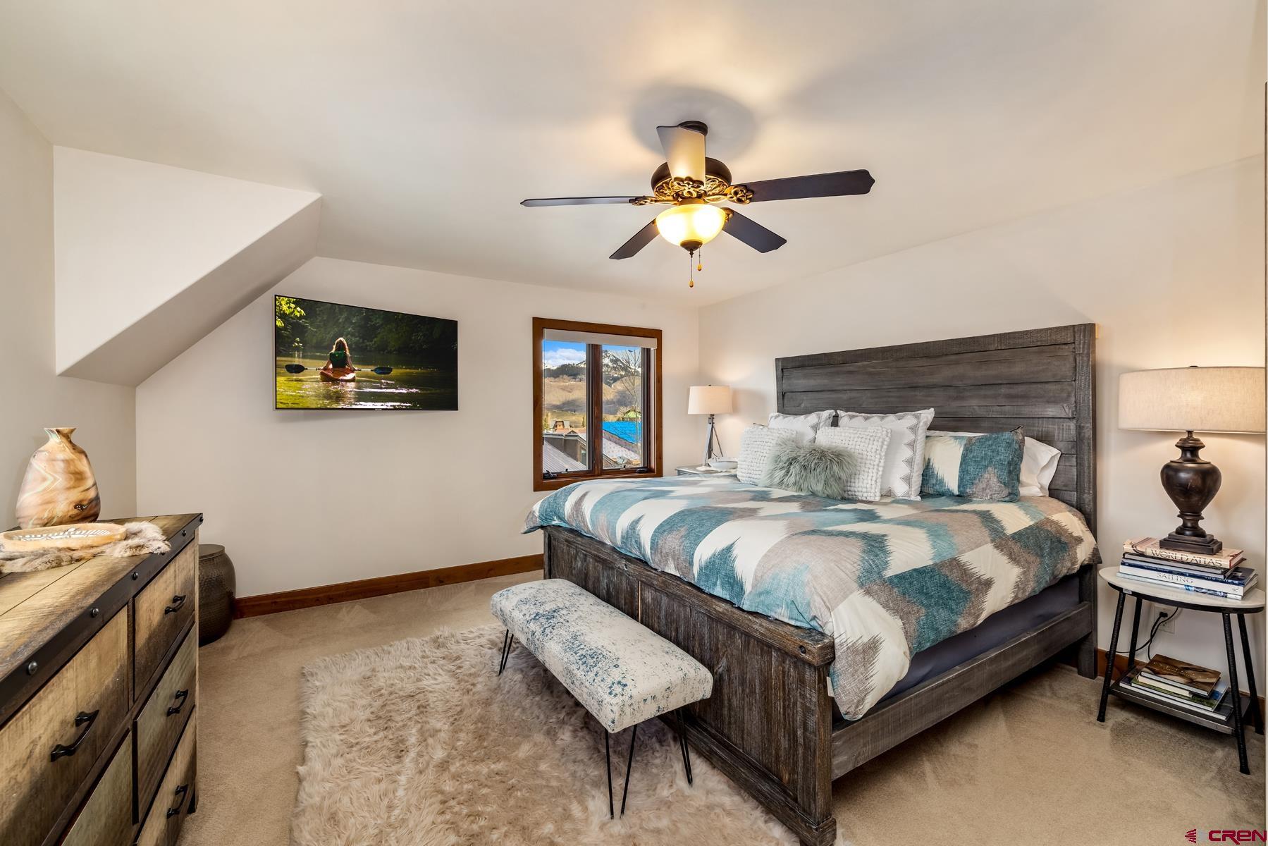 32 Cinnamon Mountain Road Crested Butte, CO 81225 - Photo 25 of 44 a bedroom with a bed wooden floor and window