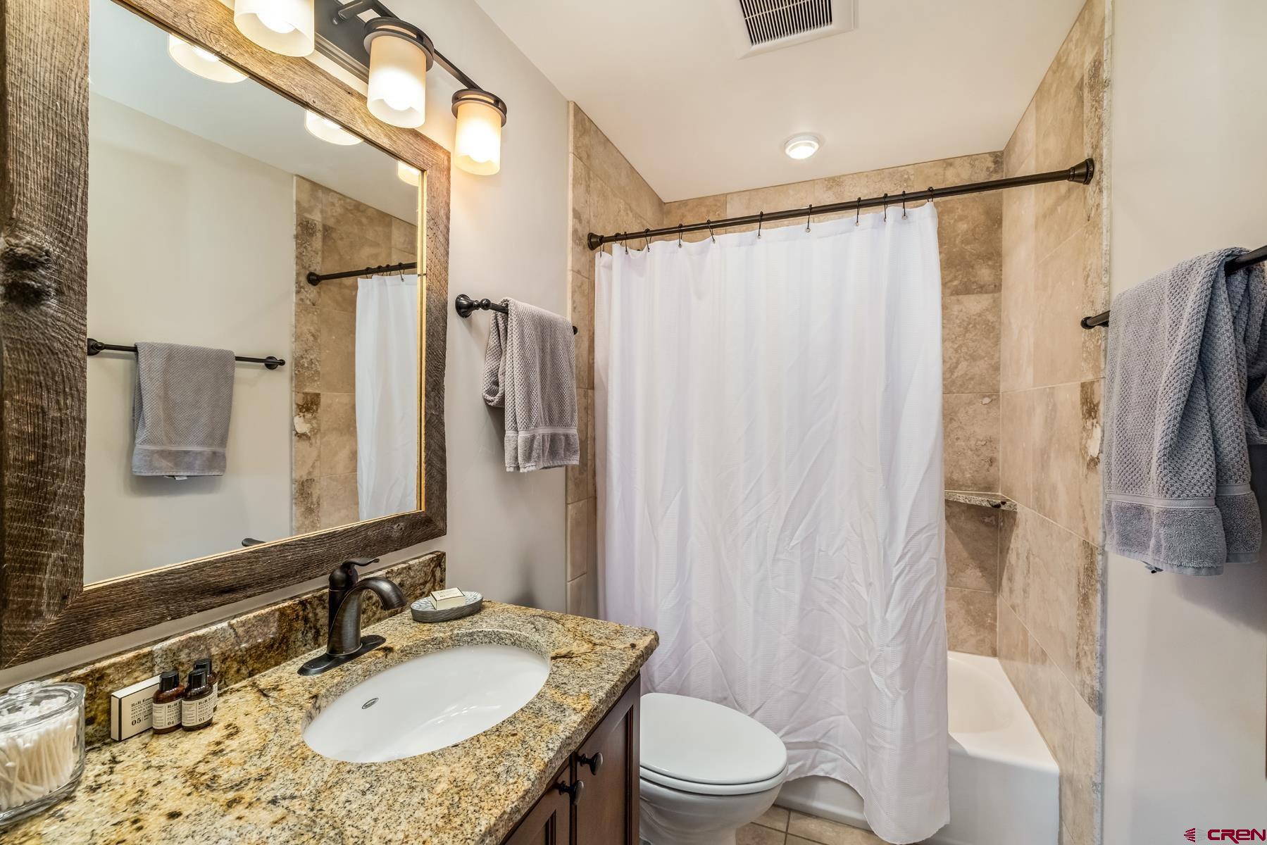32 Cinnamon Mountain Road Crested Butte, CO 81225 - Photo 26 of 44 a bathroom with a granite countertop sink toilet and shower