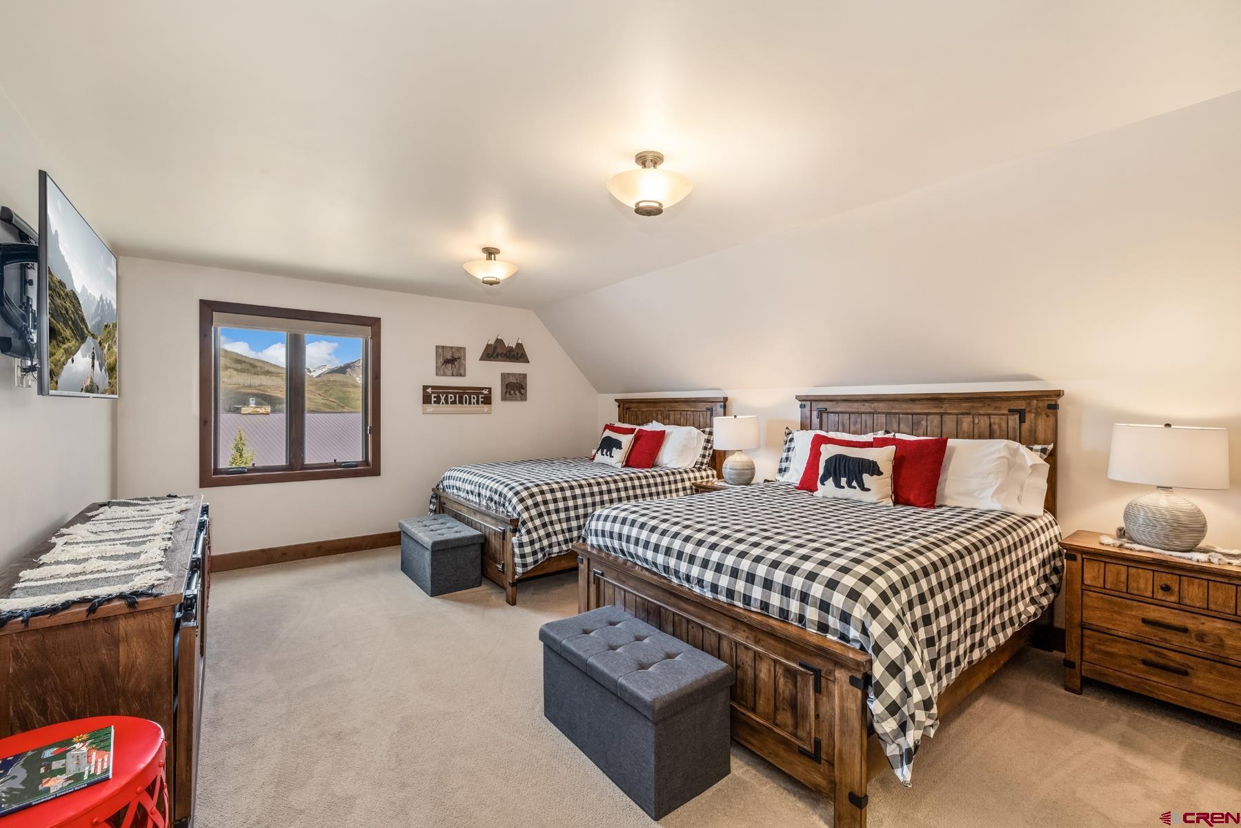 32 Cinnamon Mountain Road Crested Butte, CO 81225 - Photo 27 of 44 a bedroom with two beds and painting on the wall