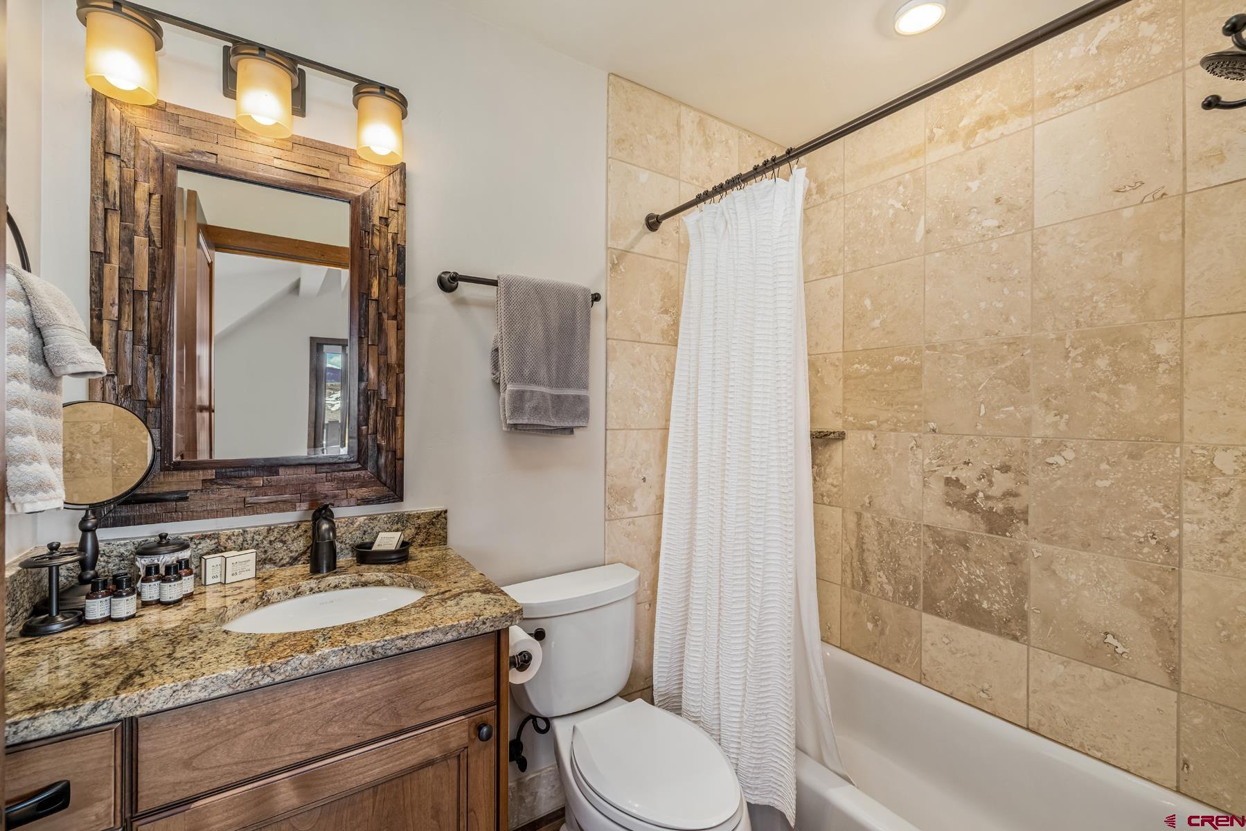 32 Cinnamon Mountain Road Crested Butte, CO 81225 - Photo 34 of 44 a bathroom with a granite countertop sink toilet and shower